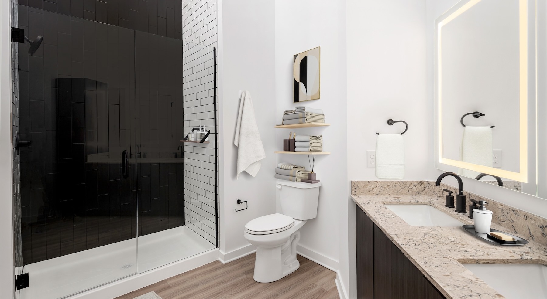 Sophisticated primary bathroom illuminated by halo mirrors
